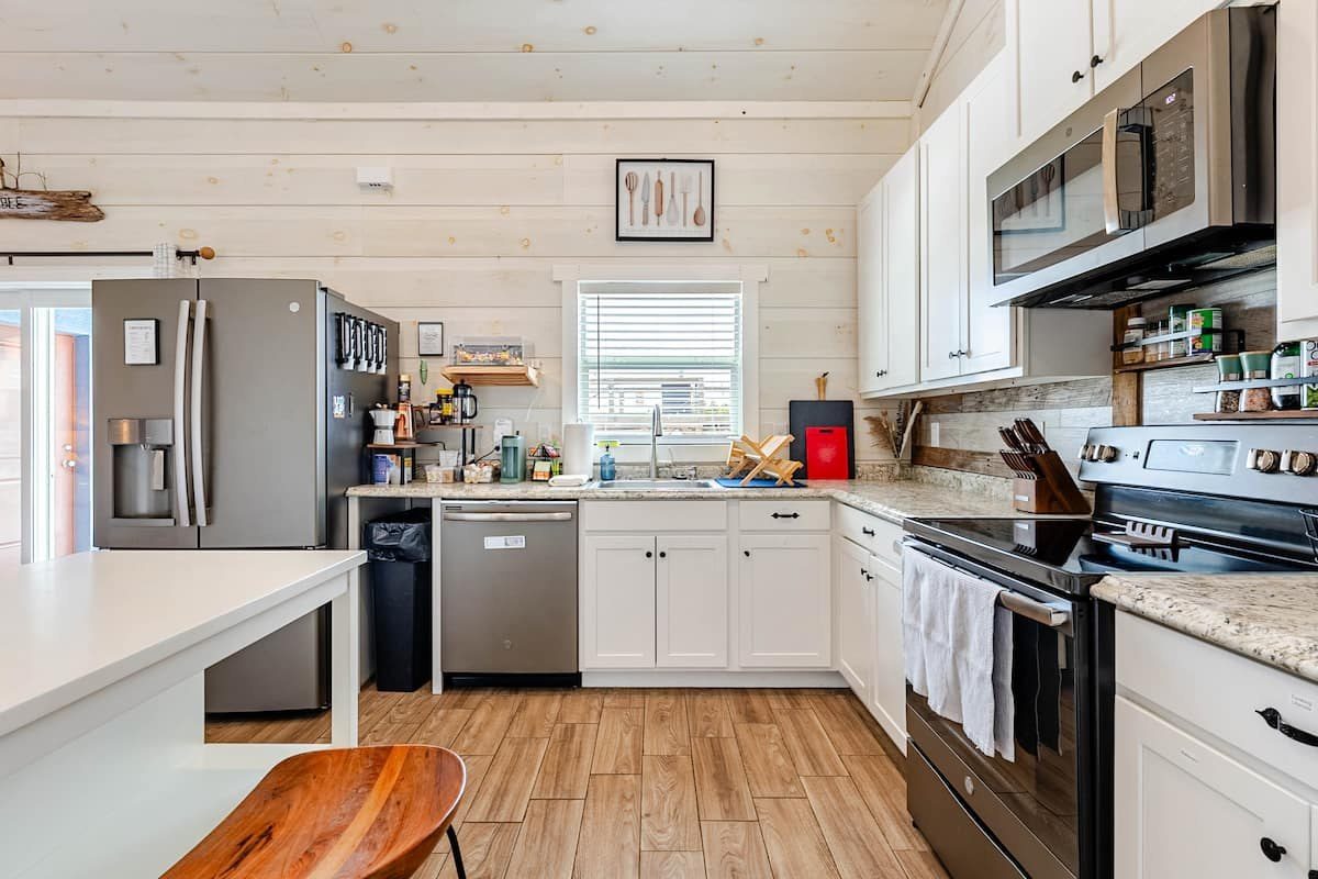 White kitchen with stainless appliances