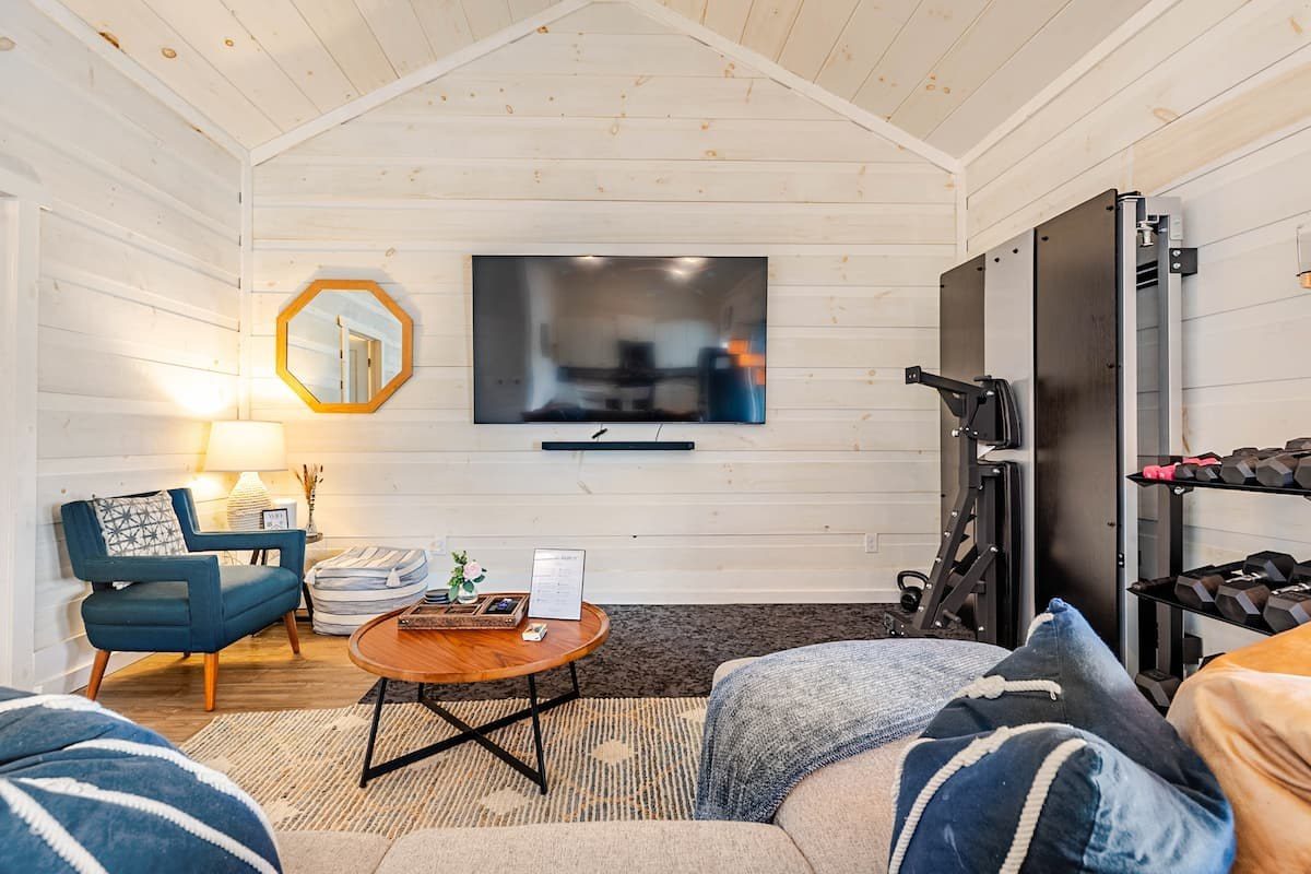 Sitting area with a blue armchair and TV